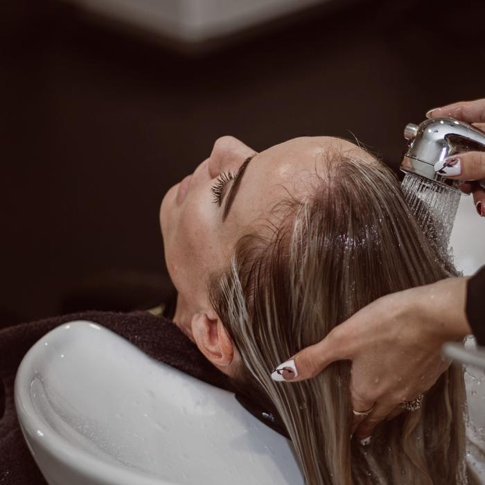 Cliente de olhos fechados durante a lavagem